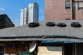 Car tires lying with on the rooftop so that the roof is not blown away by the wind. It`s time to repair the roof. Leaky