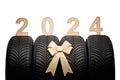 Car tires, new year 2024 tyres, winter wheels golden christmas ribbon Royalty Free Stock Photo