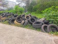 Car tires that are no longer suitable for use are piled up in large piles