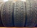 Car tires on shelf in auto repair shop, closeup. Auto service industry Royalty Free Stock Photo