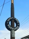 car tires that are used as billboards for a tire patch business on the side of the road