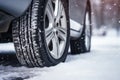 Car tires in winter on the road covered with snow. Generative AI