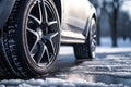 Car tires on winter road covered with snow. Vehicle on snowy road in the morning at snowfall