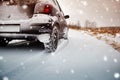 Car tires on winter road covered with snow Royalty Free Stock Photo