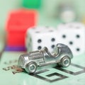 Car token on a monopoly game board