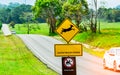 Car of the tourist driving with caution during travel at asphalt road near yellow traffic sign with deer jumping inside the sign