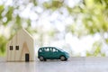 Car and a toy house on the wooden floor and have copy space Royalty Free Stock Photo
