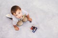Car, toys and portrait of kid playing for learning, development and fun at modern home. Cute, top view and sweet young Royalty Free Stock Photo