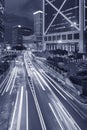 Car traffic in central district of Hong Kong city at night in monochrome Royalty Free Stock Photo