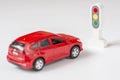 A car and traffic llight on a white background. Traffic Laws