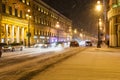 Car traffic on Nevsky Prospect street in snowfall