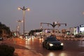 Car traffic at night in the city center. Lanterns with night illumination, moving cars with their headlights on