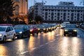 Car traffic at rush hour on the main boulevard in Bucharest downtown. Rainy morning, rainy evening during winter in Bucharest,