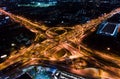 Car traffic transport on multiple lane highway or winding road expressway in Asia city at night, drone aerial view