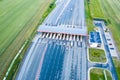 Car traffic transportation on multiple lanes highway road and toll collection gate, drone aerial top view. Commuter transport,
