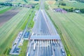 Car traffic transportation on multiple lanes highway road and toll collection gate, drone aerial top view. Commuter transport,