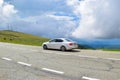 Car on the Transalpina serpentines road DN67C. This is one of the most beautiful alpine routes in Romania Royalty Free Stock Photo