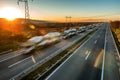 Car Transporter Trucks - Fast blurred motion drive on the freeway at sunset Royalty Free Stock Photo