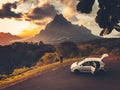 Car travel concept. People watch mountain sunset