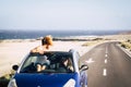 Car travel friends transportation two happy woman ejoy convertible auto together in summer trip holiday vacation - ocean and beach Royalty Free Stock Photo