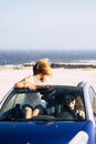 Car travel friends transportation two happy woman ejoy convertible auto together in summer trip holiday vacation - ocean and beach