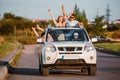 car travel. fun happy people stick put of sun roof