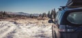 car for traveling with a winter mountain road Royalty Free Stock Photo