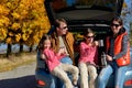 Car trip on autumn family vacation, happy parents and kids travel Royalty Free Stock Photo