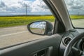 Car trip. Road view reflection on side mirror Royalty Free Stock Photo