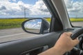 Car trip. Road view reflection on side mirror