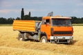 Car Truck on wheat field, harvesting