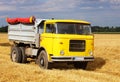 Car Truck on wheat field, harvesting