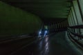 Car tunnel in the Alps with oncoming traffic, Austria