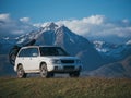 The car with two bicycle mounted to the roof bike with bikepacking. The trip outdoor road in mountain snow capped.