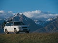 The car with two bicycle mounted to the roof bike with bikepacking. The trip outdoor road in mountain snow capped.