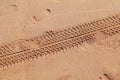 Car tyre traces on beach sand Royalty Free Stock Photo