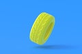 Car tyres of yellow color on blue background. Automotive parts
