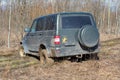 The car UAZ-Patriot is stuck in the mud while crossing the forest belt
