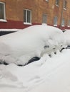 A car under a pile of snow after a very heavy snowfall