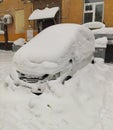 A car under a pile of snow after a very heavy snowfall