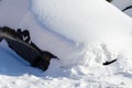 Car under snowdrift in city yard after snowfall Royalty Free Stock Photo