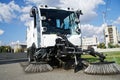 Car - vacuum cleaner and sweeper for cleaning city streets. Municipal economy and improvement Royalty Free Stock Photo