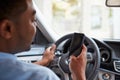 In car view of young male African American holding his phone Royalty Free Stock Photo