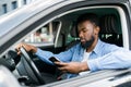 Young male African American holding his phone while drive his car Royalty Free Stock Photo