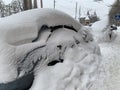 The car was covered with snow in the parking lot. Cars under a large layer of snow. Snowfall on the streets of Europe Royalty Free Stock Photo