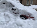 The car was covered with snow in the parking lot. Cars under a large layer of snow. Snowfall on the streets of Europe Royalty Free Stock Photo