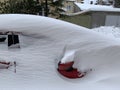 The car was covered with snow in the parking lot. Cars under a large layer of snow. Snowfall on the streets of Europe Royalty Free Stock Photo