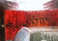 Car wash automatic, red rotating brushes, water spray