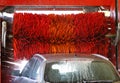 Car wash automatic, red rotating brushes, water spray