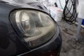 Close Up of dirty yellow car headlight in the shop